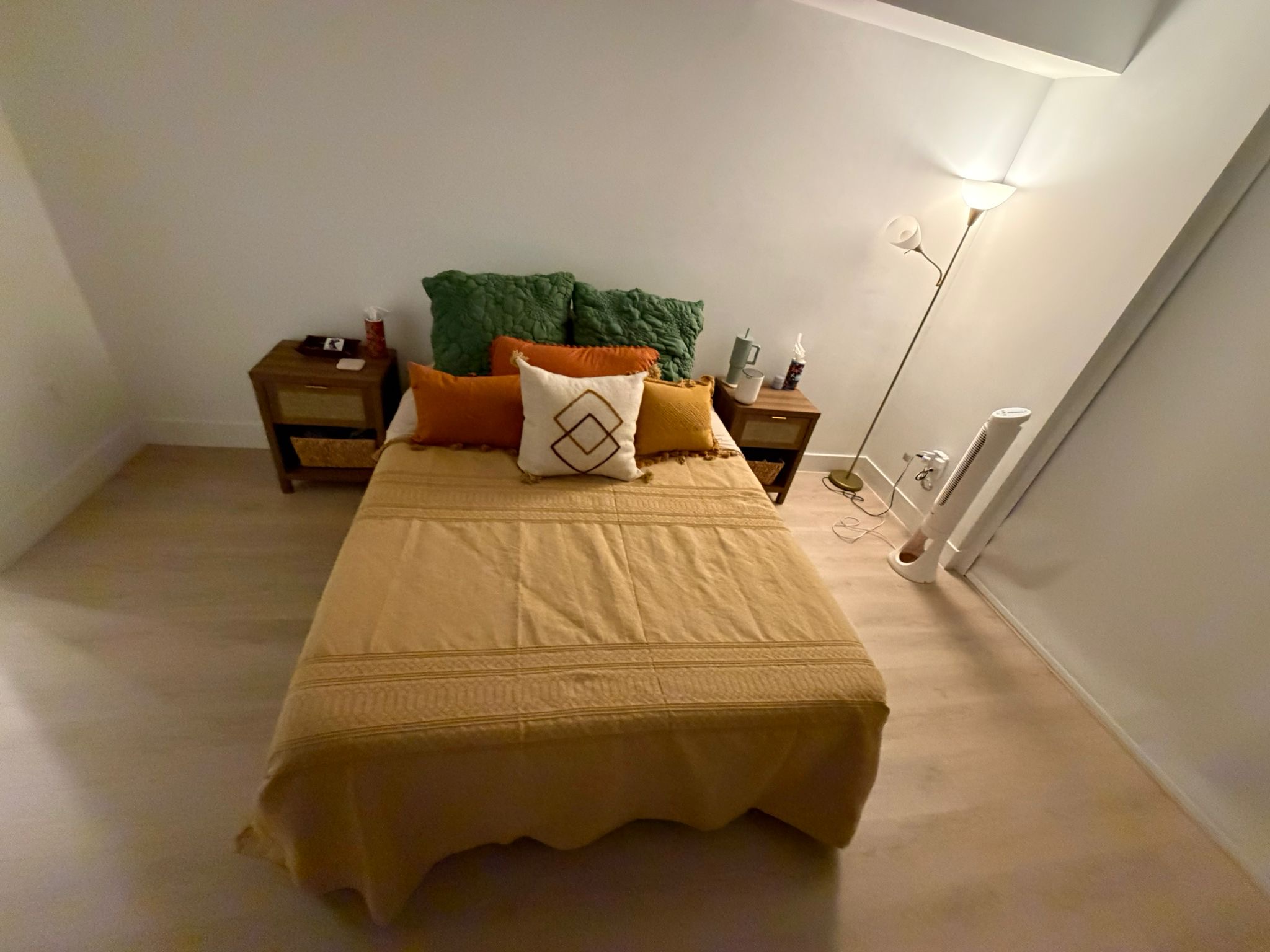 Freshly cleaned bedroom with neatly made bed after residential cleaning services.