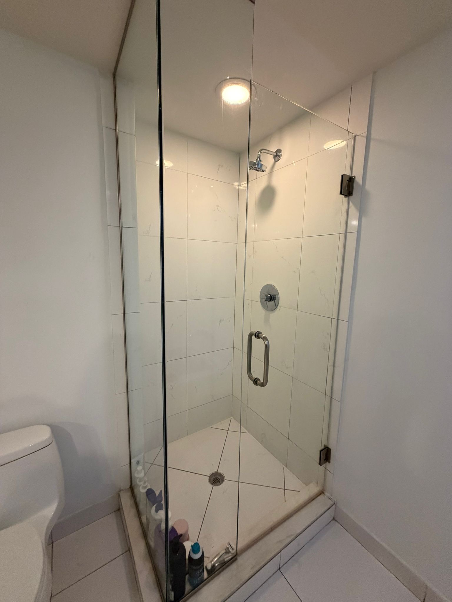 Sparkling glass shower professionally cleaned by a residential cleaning company in Dallas, TX.