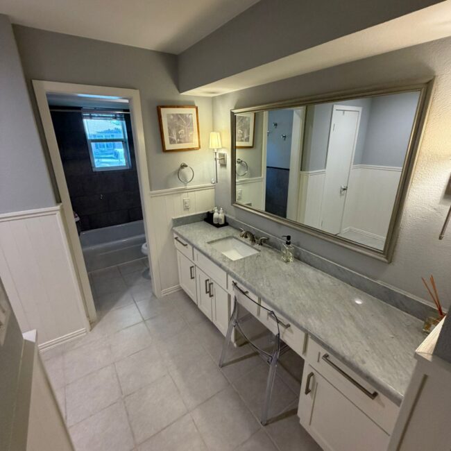 After photo of a professionally cleaned bathroom in Dallas TX by Monarch Texas Cleaning. Toilet scrubbed inside and out, sink sanitized, mirrors cleaned, and floors mopped.